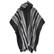 Llama Wool Hooded Poncho – a black and gray poncho hangs vertically, featuring alternating striped patterns. The fabric flows naturally, suggesting a loose, comfortable fit. The background is plain and white, emphasizing the poncho