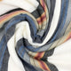 Siguitag alpaca wool throw blanket – a colorful, striped fabric is intricately twisted in a spiral pattern, showcasing hues of blue, gray, orange, and white. It creates a dynamic, visually engaging texture