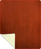A brown rectangular rug lies flat with its corner slightly flipped, revealing a lighter underside. The rug's texture appears soft, set against a plain background.