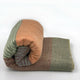 Latacunga alpaca wool throw blanket – a rolled, multi-colored wool blanket with soft, muted tones of brown, orange, and green rests on a plain white background