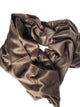 Pilahuin baby alpaca wool blanket – a soft, brown, velvet blanket is loosely twisted and laid against a plain white background