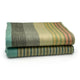 Cojitambo alpaca wool throw blanket – a folded, striped blanket lies neatly on a white surface. The blanket features wide horizontal stripes in shades of green, beige, and salmon, alternating with thinner multicolored stripes