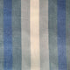 Poguios baby alpaca wool blanket – vertical stripes in alternating shades of blue and gray cover a textured fabric surface, creating a soothing and uniform pattern. The background appears smooth and consistent