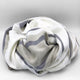 Yacoubina baby alpaca wool blanket – a soft, striped wool blanket is casually crumpled together, displaying gray and beige tones against a plain, neutral background