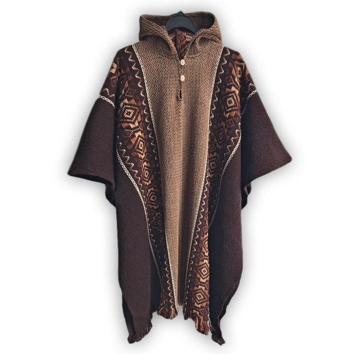 A brown knit poncho with geometric patterns drapes over a black hanger. It features a hood and buttons down the front, displayed against a plain white background.