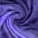 Yatzaputzan baby alpaca wool blanket – purple fabric forms a soft, swirling pattern, creating gentle folds and textures, resembling a twisted, cozy textile design. The lighting enhances its rich, vibrant hue