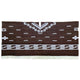 Clint Eastwood alpaca wool poncho – a brown textile features white geometric patterns, including stepped designs and horizontal lines, with a fringe at the bottom. The design is symmetric and appears on a plain background