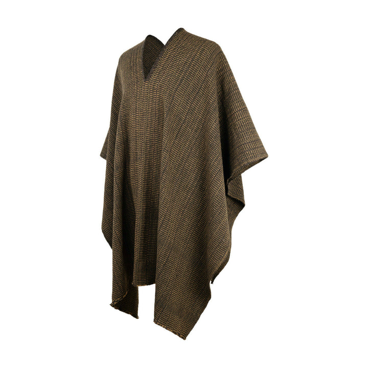A brown, patterned poncho hangs freely, displaying its loose, draping fabric in a studio setting with a neutral white background.