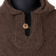 A brown woolen garment with a single tan button, displayed on a black mannequin torso against a neutral background.