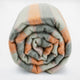 Tumbunuma baby alpaca wool blanket – a rolled-up wool blanket displays orange and gray stripes, tightly wrapped, set against a plain white background