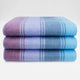 Tinizaray baby alpaca wool blanket – three folded blankets lie stacked with alternating stripes of blue, purple, and red hues, creating a harmonious color gradient against a plain white background