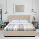 Yankuam baby alpaca wool blanket – a beige bed with a tufted headboard is covered with a striped blanket in a modern bedroom. It is flanked by nightstands; a chair and pendant lights adorn the room