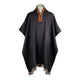 A dark, woolen poncho with a fringed hem and decorative red-yellow embroidered collar is displayed against a plain white background.