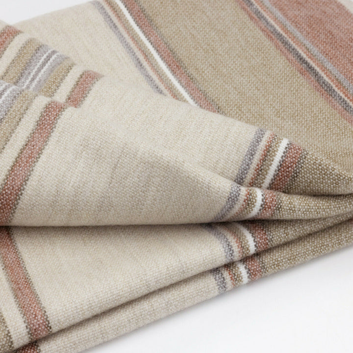 Zhumir baby alpaca wool blanket – a folded, striped, beige blanket features brown, red, and gray lines, resting on a white surface, showcasing its soft texture and pattern