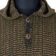 Zampu thick llama wool hooded poncho – a close-up of a brown and black checkered wool coat with two dark brown buttons, displayed on a black mannequin torso. The texture appears thick and woven