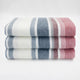Pindo baby alpaca wool blanket – three neatly folded blanket, featuring red, blue, and white stripes, are stacked on top of each other against a plain white background