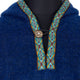 A blue woolen garment features a buttoned neckline with intricate blue and orange diamond-patterned trim, displayed on a black mannequin backdrop.
