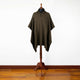 Zampu thick llama wool hooded poncho – a dark brown poncho with a collar and buttons drapes over a mannequin stand, set against a white wall and wooden floor background