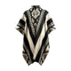 A poncho displays geometric patterns in black and cream, featuring zigzags and triangles. It hangs against a plain, light background, highlighting its traditional design and earthy colors.