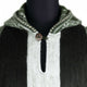 Hooded sweater with vertical black and white stripes, a plaid-lined hood, and a single button closure, displayed on a black mannequin in a plain setting.