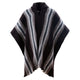 A woolen poncho hangs isolated on a white background, featuring bold black and gray diagonal stripes and a single button at the neckline.