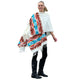 A person wearing a colorful, fringed shawl with geometric patterns is standing and smiling. The context is a plain white background, focusing on the shawl's vibrant design.
