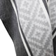 Gray and white fabric with a geometric pattern drapes and folds. The pattern consists of pixelated shapes, framed by dark and light stripes, suggesting a cozy textile surface.