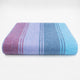 Tinizaray baby alpaca wool blanket – a folded, striped blanket features vertical bands of blue, purple, and burgundy hues. It rests against a plain, white background, showcasing its soft, textured material