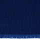 Dark blue woven fabric with a fine texture, featuring fringe at the bottom edge, suggesting a textile product, possibly a shawl or blanket, against a plain background.