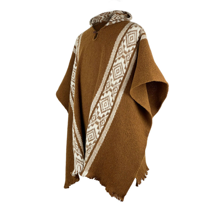 A brown poncho with geometric patterns in white is displayed on a plain white background. The poncho features a fringed hem and a cozy, textured design.
