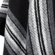 A textured fabric displays diagonal stripes in shades of black, gray, and white, creating a soft, woolen appearance in a close-up view.