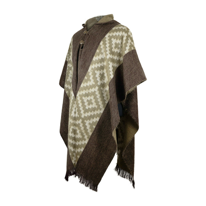 A brown and beige poncho with geometric patterns drapes over a mannequin, fastened with wooden buttons, set against a plain white background.