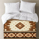Two white pillows and a matching sheet lie on a bed, covered with a southwestern-style blanket featuring geometric patterns in brown, beige, and orange tones.