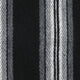 Wool fabric displaying vertical, alternating black, grey, and white stripes, creating a textured pattern across the surface.