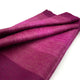 Chontamarca baby alpaca wool blanket – a folded, gradient magenta fabric lies neatly against a plain white background, showcasing its soft texture and rich color variation
