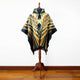 Shakai alpaca wool hooded poncho – a poncho with geometric patterns in brown, black, and beige is displayed on a wooden mannequin stand. The setting features a simple wooden floor against a plain white background
