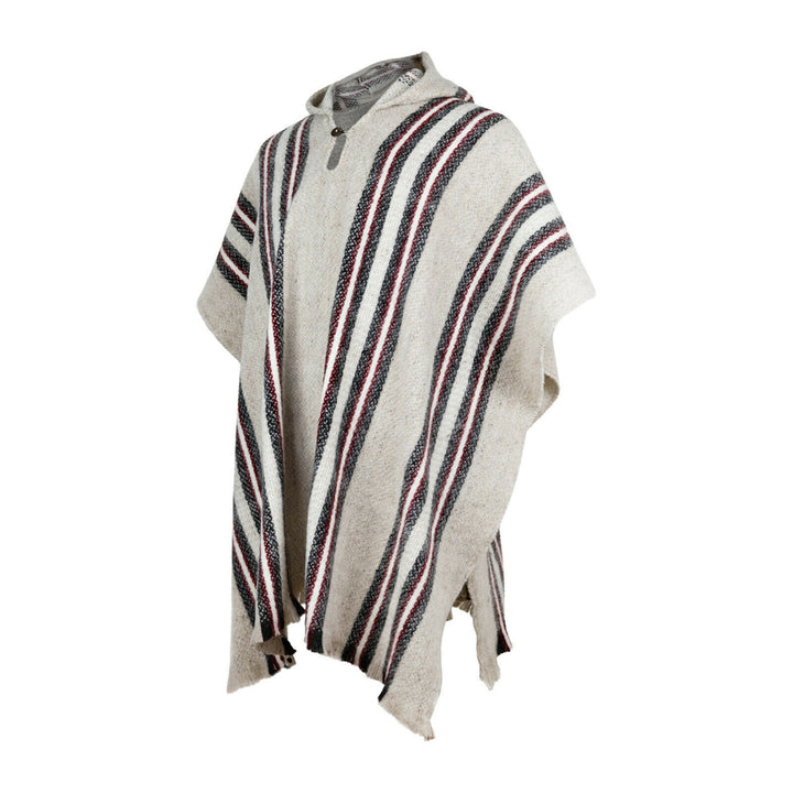 A woolen poncho with vertical black, red, and white stripes hangs freely against a plain white background, showing its loose, flowy design and single button closure near the collar.